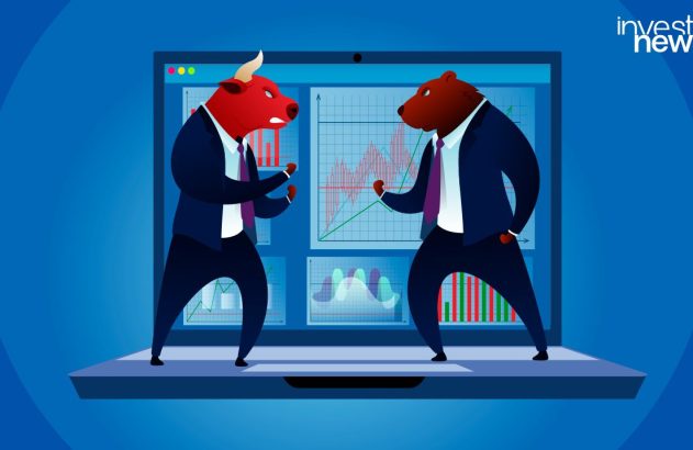 Touro e urso em ternos se confrontam sobre um laptop com gráficos financeiros.