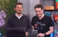 Dois homens sorrindo em um cenário de estúdio. O da direita veste camiseta com tema de matemática. Há laptops e decoração.