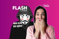 Mulher chocada com figura de capuz e máscara Anonymous; texto: 'Novo vilão das ações?'