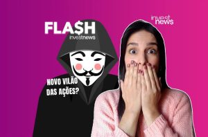 Mulher chocada com figura de capuz e máscara Anonymous; texto: 'Novo vilão das ações?'