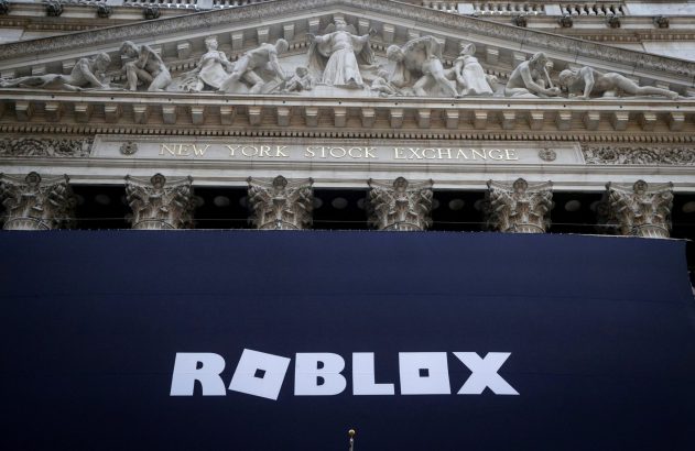 Fachada da New York Stock Exchange (NYSE) com estátuas, exibindo banner preto com logo ROBLOX.