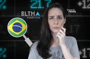 Mulher com expressão de dúvida olhando dados financeiros. Uma lupa exibe a bandeira do Brasil. Logotipo Investnews.