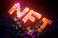 Palavra NFT em blocos 3D luminosos e coloridos sobre grade escura de cubos.