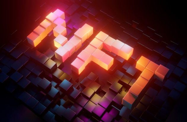 Palavra NFT em blocos 3D luminosos e coloridos sobre grade escura de cubos.