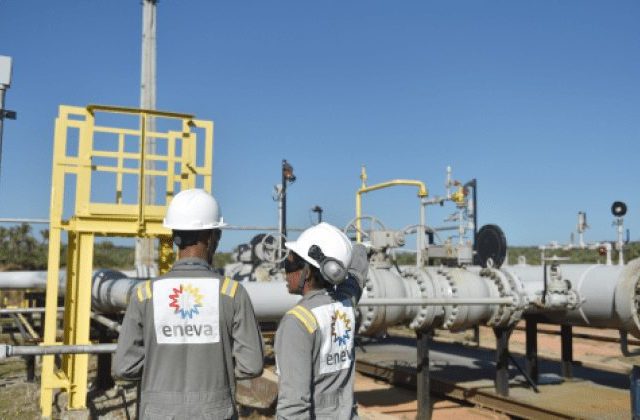 Trabalhadores da Eneva de uniforme olham a usina