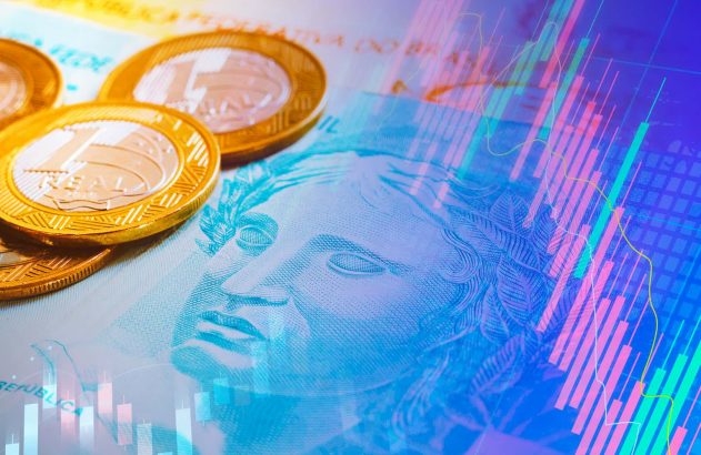 Moeda real em cima de uma cédula de dinheiro