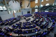 Sessão plenária no Bundestag, Alemanha, com deputados sentados e a águia federal proeminente.