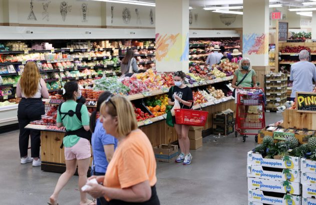 Clientes comprando frutas e vegetais em um Trader Joe's.