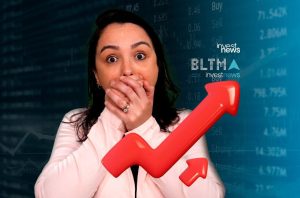 Mulher chocada com a boca coberta por mãos, em frente a gráficos de mercado financeiro e uma seta de alta.