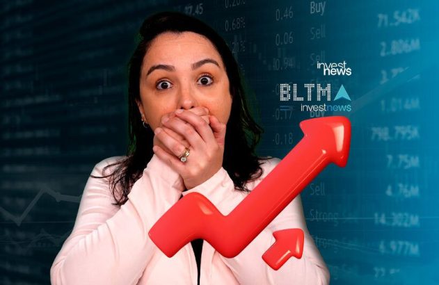 Mulher chocada com a boca coberta por mãos, em frente a gráficos de mercado financeiro e uma seta de alta.