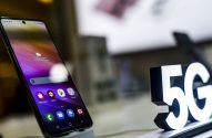 Celular exibindo tela com aplicativos e letreiro "5G" luminoso em destaque.