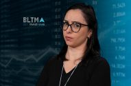 Mulher de óculos, expressão questionadora, em frente a dados e gráficos de mercado, com logo BLTMA investnews.