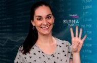 Mulher sorridente levanta quatro dedos, com fundo azul de gráficos financeiros e logos "investnews".