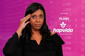 Mulher preocupada com a mão na testa, em fundo rosa com dados financeiros e logos de notícias/saúde.