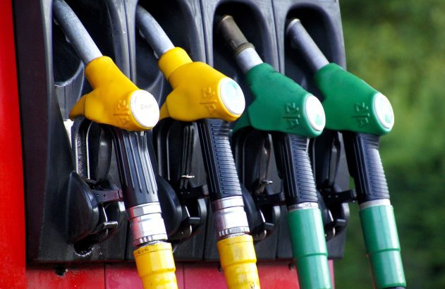 Quatro bicos de combustível, dois amarelos (diesel) e dois verdes, em bomba de gasolina.