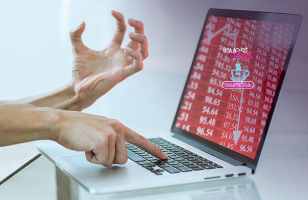 Pessoa em desespero usando laptop que exibe perdas financeiras em tela vermelha.