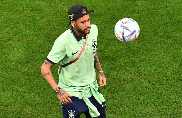 Neymar Jr. em campo, olhando para uma bola de futebol que flutua no ar.
