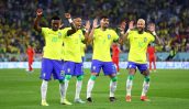 Quatro jogadores do Brasil, incluindo Neymar e Vinicius Jr., celebram em campo, com braços erguidos e sorrisos.
