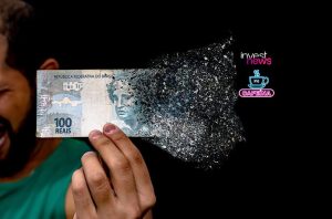 Cédula de 100 Reais brasileira desintegrando-se na mão de uma pessoa.