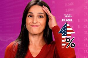 Mulher de suéter vermelho com mão na testa. Ao fundo, dados financeiros e seta com bandeira dos EUA e símbolo de %. Notícia: "Invest News FLASH".