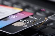 Anzol fisgando cartão de crédito em teclado, simbolizando roubo de dados ou phishing.