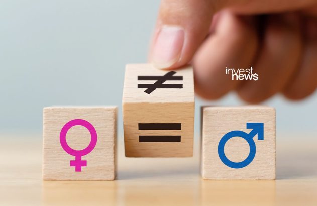 Mão manuseia bloco de madeira com sinais de igualdade/desigualdade, entre símbolos feminino e masculino. investnews.