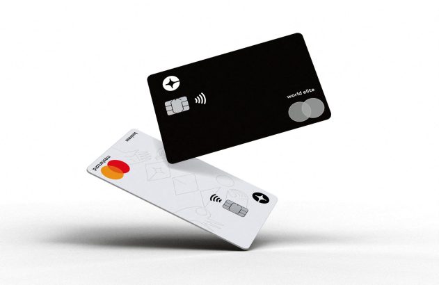 Dois cartões de crédito flutuando: um preto World Elite e um branco Business, ambos Mastercard.