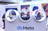 Pessoas interagem com displays circulares em estande da Meta, destacando "Meta for Work".
