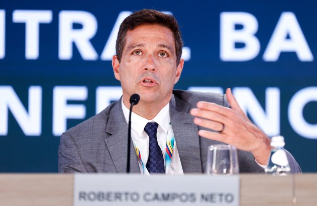 Roberto Campos Neto, presidente do BC, fala em conferência, gesticulando com a mão.