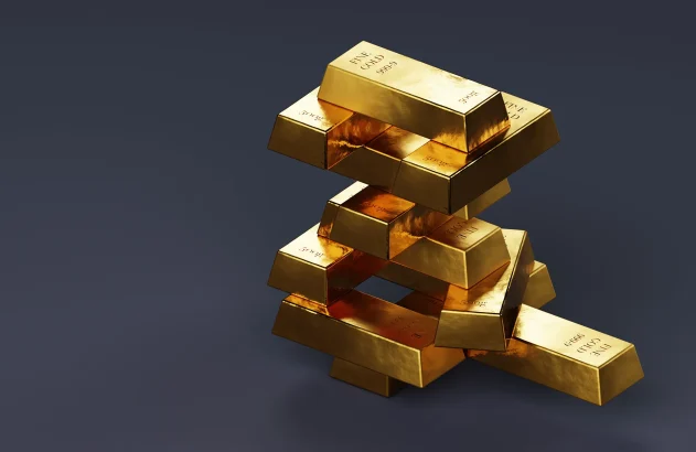 Pilha de barras de ouro em fundo cinza; valorização do ouro