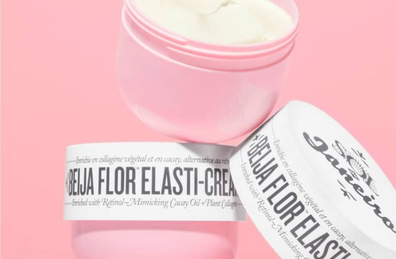 Dois potes rosa de creme "Beija Flor Elasti-Cream" da Sol de Janeiro, um aberto e o outro deitado.