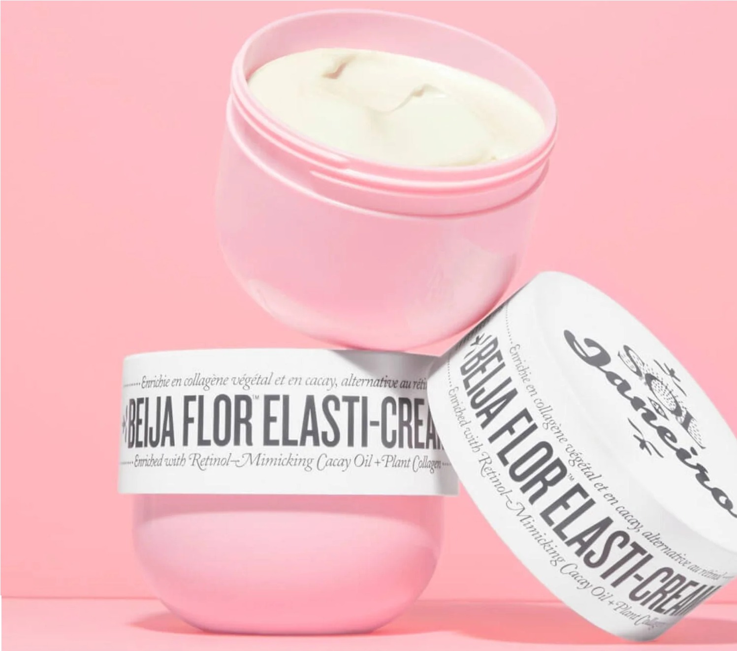 Dois potes rosa de creme "Beija Flor Elasti-Cream" da Sol de Janeiro, um aberto e o outro deitado.