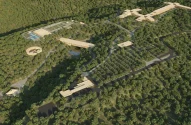 Maquete arquitetônica da Villa XP, um complexo moderno e sustentável em meio a uma floresta densa, com edifícios integrados à natureza e estruturas conectadas por estradas e caminhos.