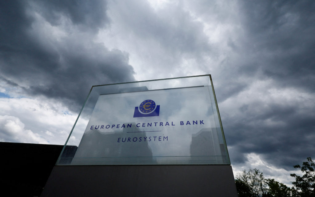 Placa de vidro do Banco Central Europeu (BCE) e Eurosistema sob céu escuro e nublado.