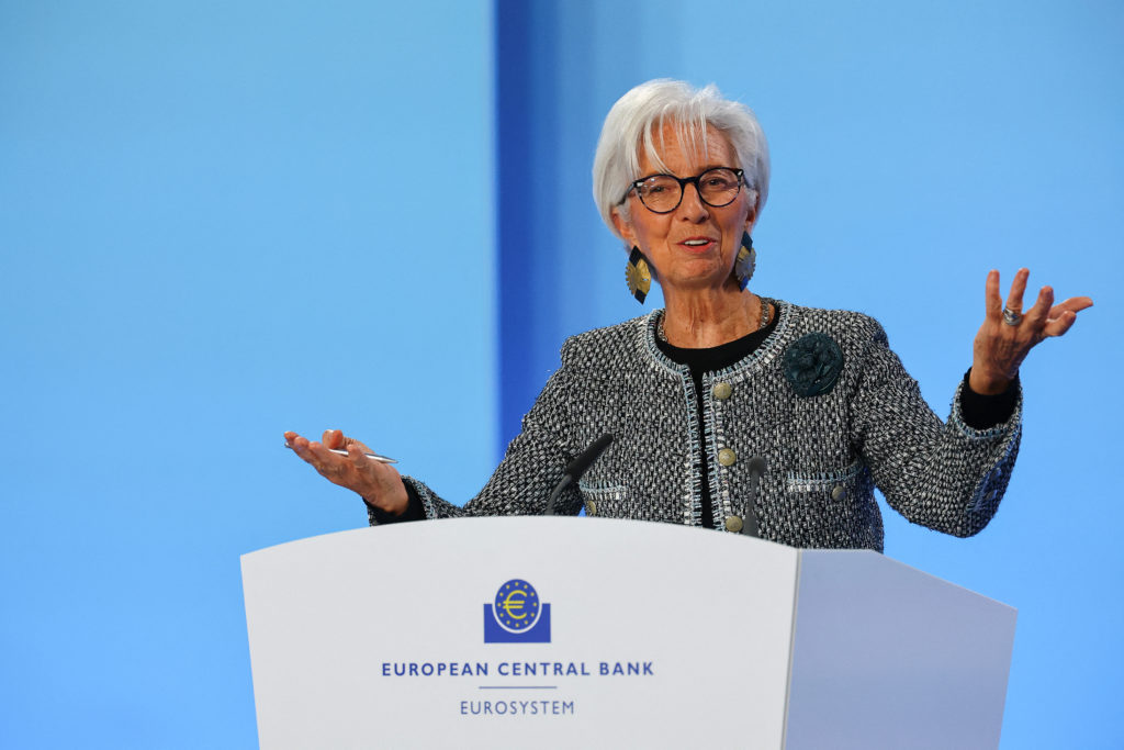 Christine Lagarde discursa em pódio do Banco Central Europeu (BCE), gesticulando com as mãos abertas.