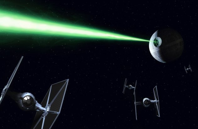 Estrela da Morte dispara laser verde no espaço, cercada por TIE Fighters.