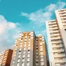 Três edifícios altos com fachada nas cores marrom, creme e cinza sob um céu azul com nuvens. Janelas alinhadas e linhas retas predominam na arquitetura urbana contemporânea.