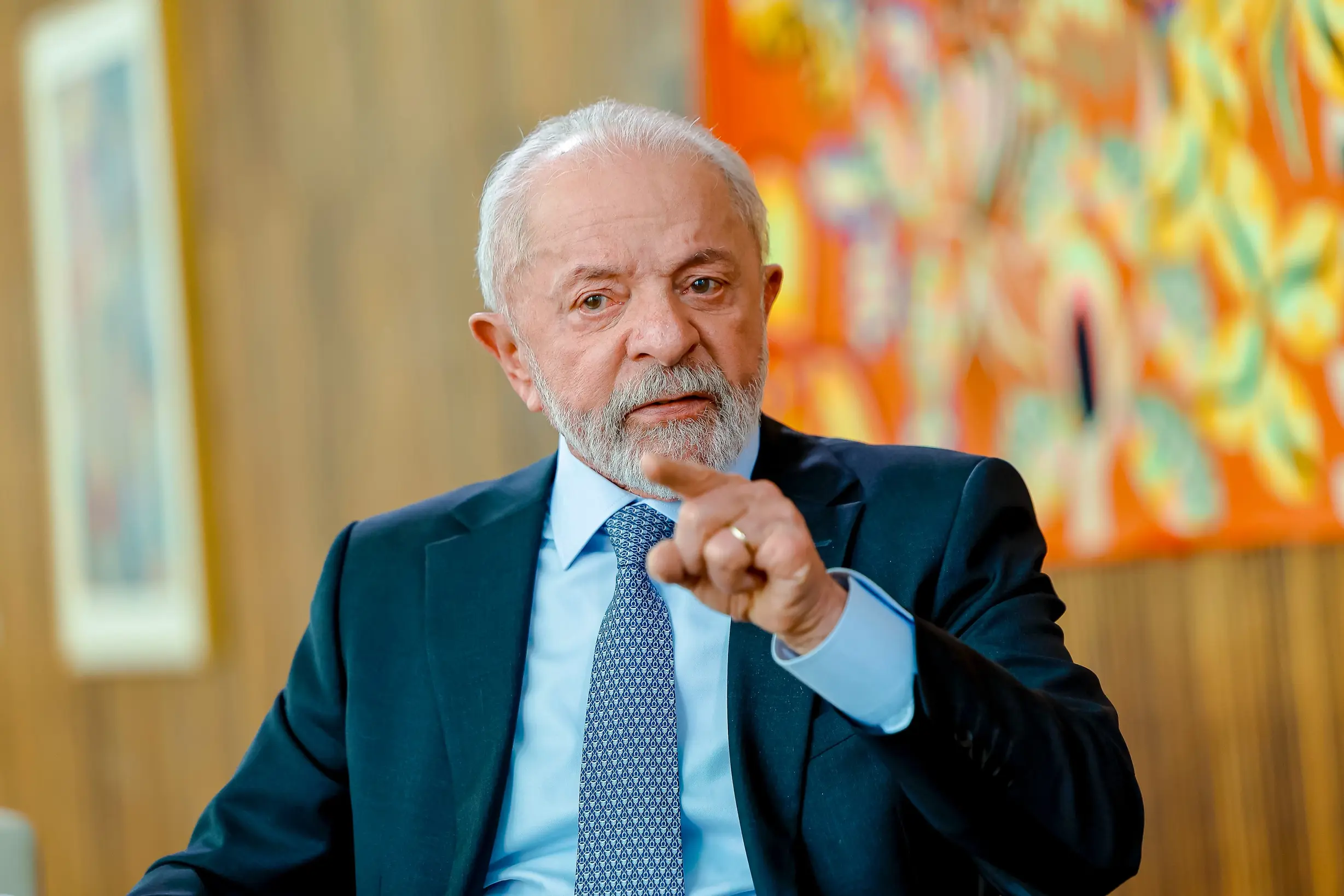 Lula in a suit pointing his finger