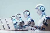 a group of robots working on laptops
