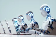 a group of robots working on laptops