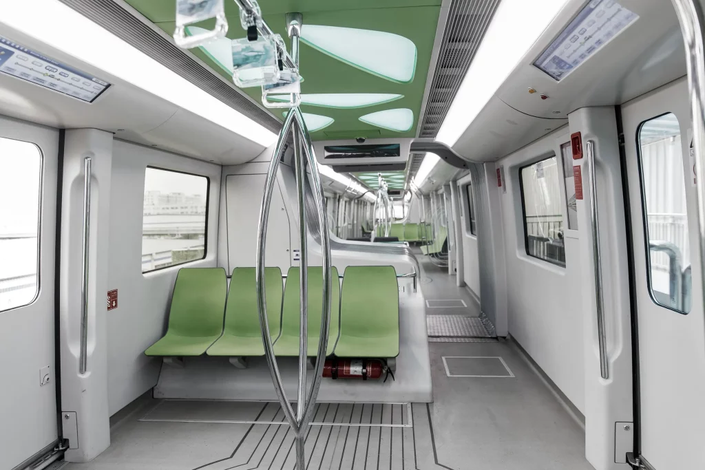 a green seats in a train BYD SkyRail