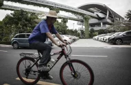 a man riding a bicycle at a BYD SkyRail