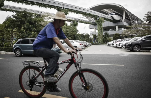 a man riding a bicycle at a BYD SkyRail