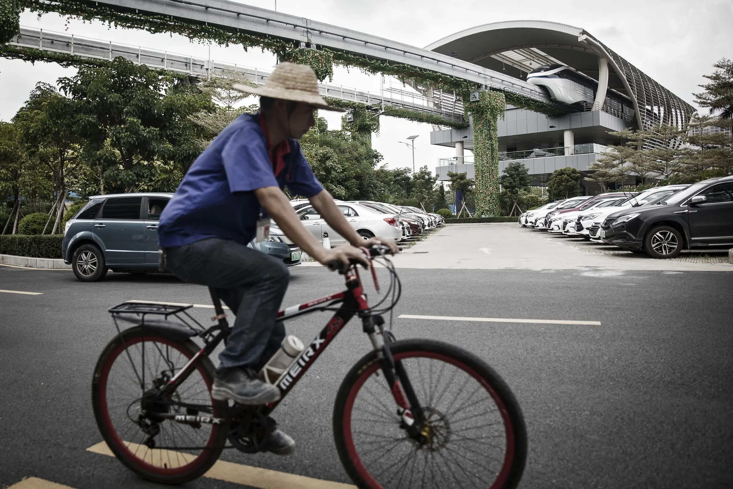 a man riding a bicycle at a BYD SkyRail