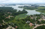 a aerial view of a lake surrounded by trees