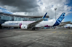 a white airplane with purple and blue design on it
