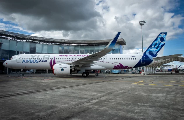 a white airplane with purple and blue design on it