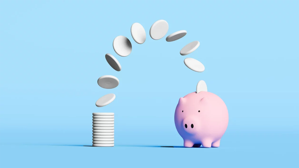 imagem de uma pilha de moeda em direção a um "porquinho" para ilustrar reportagem sobre FGC