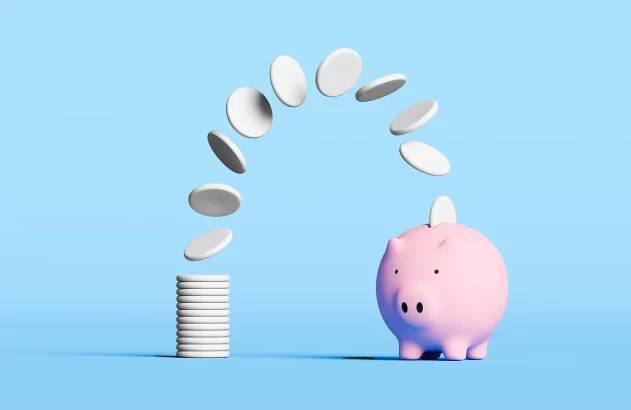 imagem de uma pilha de moeda em direção a um "porquinho" para ilustrar reportagem sobre FGC